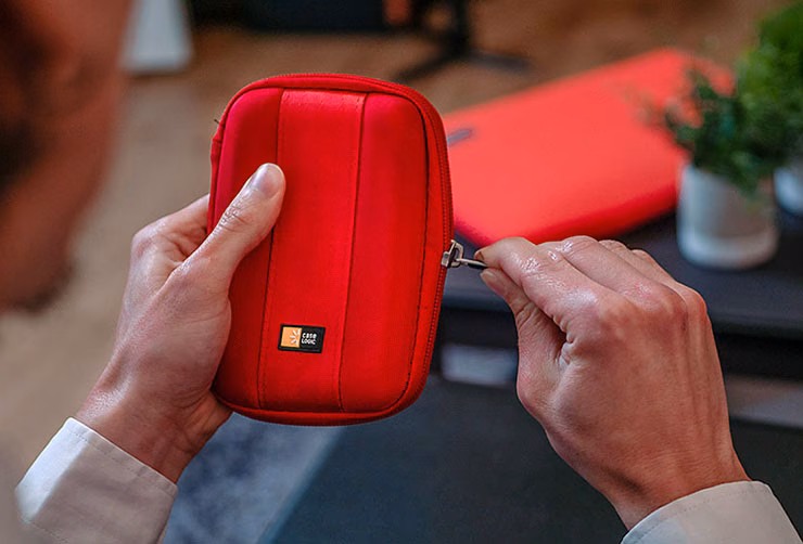 A close-up of someone closing a Case Logic electronics case.